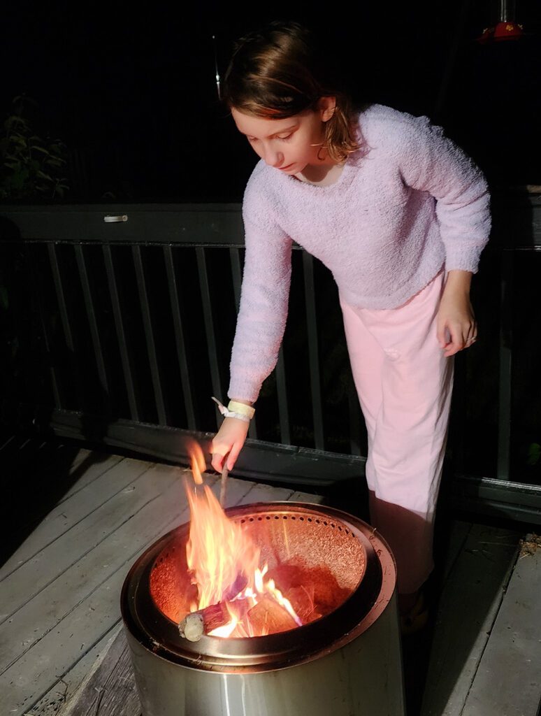 Colette roasting a marshmallow